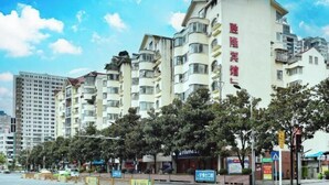 A multi-story hotel with balconies, a sign indicating a restaurant, and a clear blue sky. - Duyun Jiayuan Hotel (Duyun)