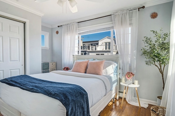 Your serene sanctuary by the shore. This bright bedroom features a plush mattres