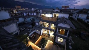 A traditional multi-story building with a courtyard, featuring a mix of residential and commercial spaces. - Erduobian Inn (Dali City)