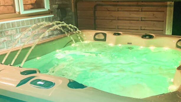 A hot tub with water jets, a control panel, and a brick wall in the background. - 2 bedroom accommodation in Bridlington (Bridlington)