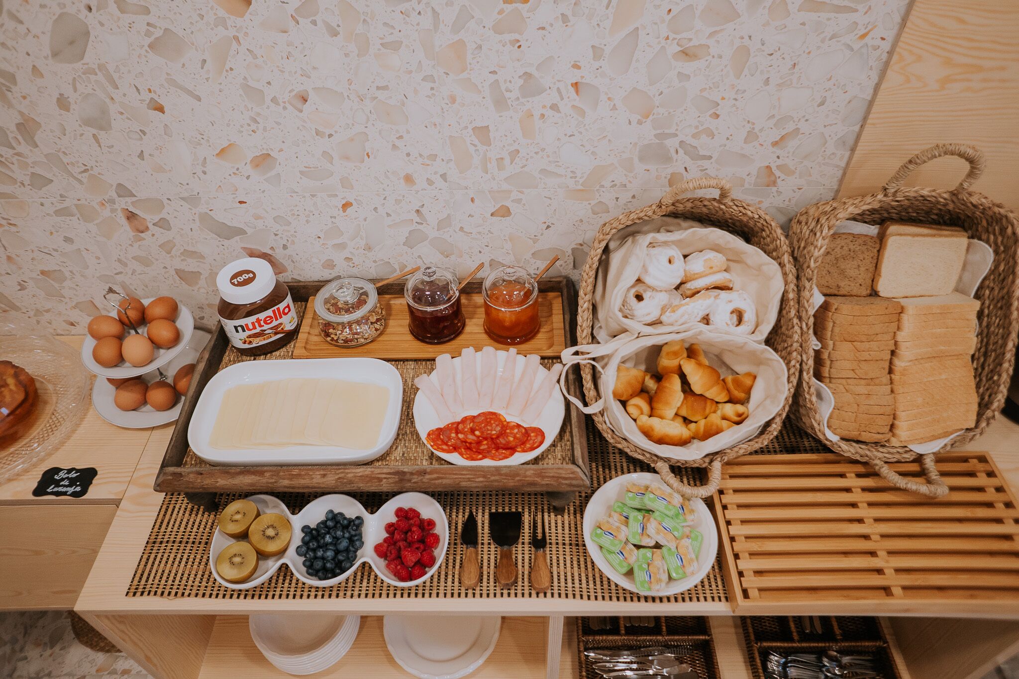 A breakfast buffet with various food items and condiments.