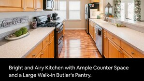 A bright and airy kitchen with ample counter space and a large walk-in Butler's pantry. - The Wild Rose ~ A Custom Glam Cottage with Theater! In Historic Old St Charles (Saint Charles)