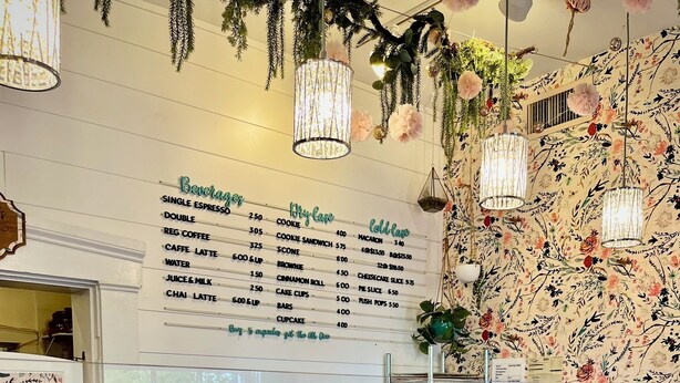 A bakery display with various baked goods and a menu listing prices. - The Wild Rose ~ A Custom Glam Cottage with Theater! In Historic Old St Charles (Saint Charles)