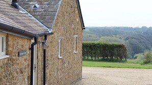 A stone building with a gravel driveway, a chimney, and a sign reading "Clayhanger Lodge." - Clayhanger Lodge  - Abbotsbury, Dorset (Abbotsbury)