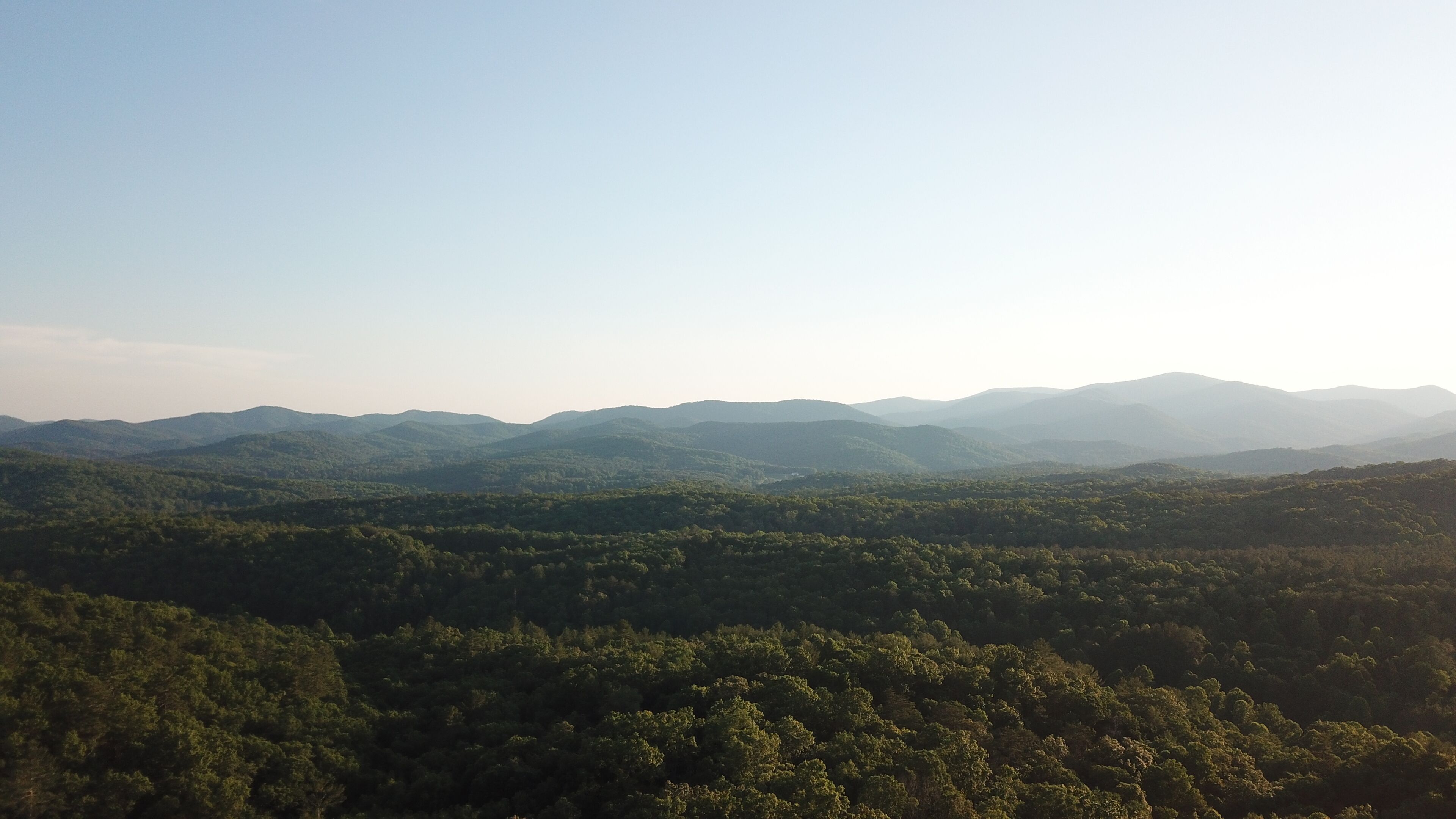A panoramic view of a mountainous landscape with dense forests.