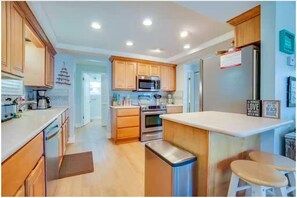 Enjoy cooking in this well-equipped kitchen with an oven, microwave, and refrigerator.