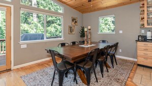 A dining room with a wooden table, six chairs, two candles, and a ceiling fan. - WALK TO LAKEMONT PINES LAKE AND ARNOLD RIM TRAIL W/AIR CONDITIONING (Arnold)
