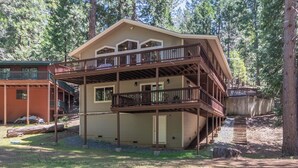 A two-story cabin with a balcony, surrounded by trees. - WALK TO LAKEMONT PINES LAKE AND ARNOLD RIM TRAIL W/AIR CONDITIONING (Arnold)