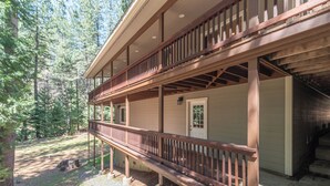 A two-story wooden cabin with a balcony, surrounded by a forest. - WALK TO LAKEMONT PINES LAKE AND ARNOLD RIM TRAIL W/AIR CONDITIONING (Arnold)
