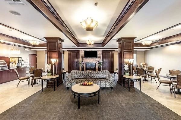 Unwind in the inviting lobby with warm lighting and seating.