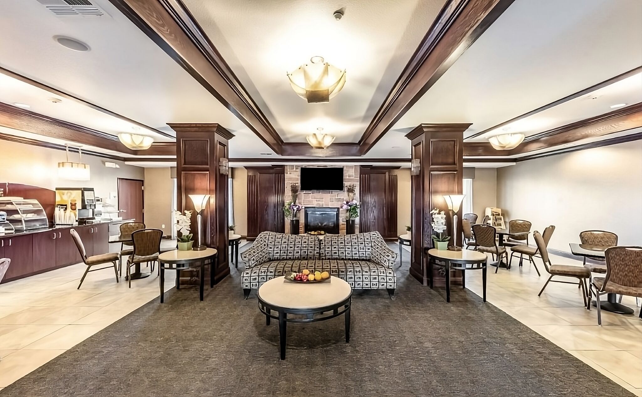 Unwind in the inviting lobby with warm lighting and seating.