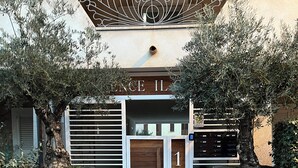A building with a sign reading 'Residence IL' and a number '10' indicating its address. - stunning aparment with private pool - 5 min from the beach (Palau)