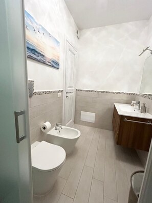 Ein Badezimmer mit Toilette, Bidet und Waschbecken.
