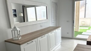 A kitchen with white cabinets, a wooden countertop, and a large window. - stunning aparment with private pool - 5 min from the beach (Palau)