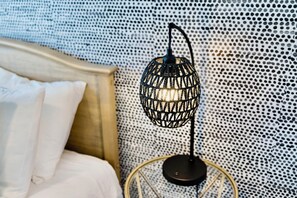A bed with white bedding and a round, black, woven floor lamp with a metal base. - Southern Craftsman · Front Porch · Fenced Yard · Patio · Walk to Five Points (Nashville)