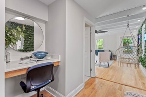 Un intérieur moderne avec un bureau, une chaise et un fauteuil suspendu.