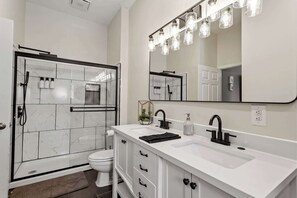 Bathtub, eco-friendly toiletries, hair dryer, towels - Warehouse District Modern Condo w/ Private Garage (Raleigh)