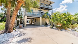 A two-story building with a covered walkway and a balcony.