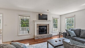 A living room with a fireplace, a sofa, and a television.