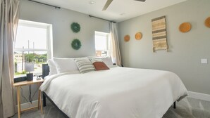 A bedroom with a bed, a desk, a ceiling fan, and a window with curtains. - Minutes to Downtown & Waterfronts with rooftop deck! (Baltimore)
