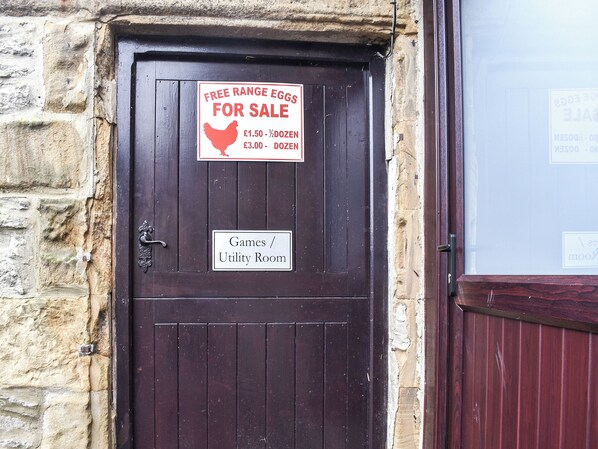A door with a sign advertising free range eggs for sale.