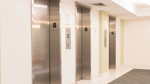 A row of elevators with floor numbers 9 and 10 visible, in a modern building with a clean, minimalist design. - Komffy Apt w/2 Queen Beds and Canal View at Tides (Hollywood)