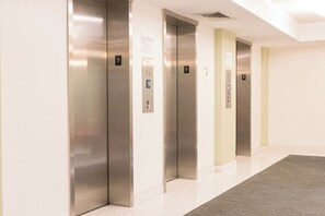 A row of elevators with floor numbers 9 and 10 visible, in a modern building with a clean, minimalist design. - Komffy Apt w/2 Queen Beds and Canal View at Tides (Hollywood)