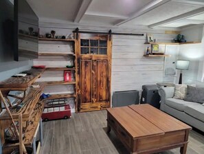 Cozy living space with a sofa, coffee table, and mounted TV.