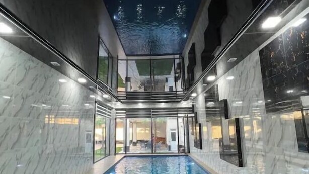 An indoor swimming pool with a glass ceiling, marble walls, and a view of the outside. - Palma Villa (Тошкент)