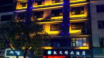 A multi-story building with illuminated signage and windows, suggesting a commercial or hotel property.