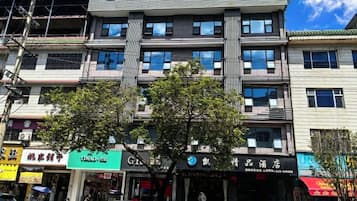 A multi-story building with a prominent sign at the top.