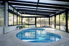 Piscine intérieure, piscine extérieure en saison, parasols