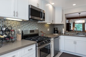 Enjoy cooking in this well-equipped kitchen with a wine rack, coffee maker, and stainless steel appliances.