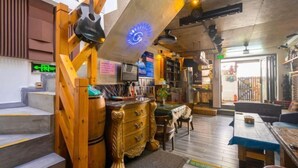 A cozy interior with a staircase, wooden furniture, and a ceiling fan. - Xiang Xie Li She Inn (Shenzhen)