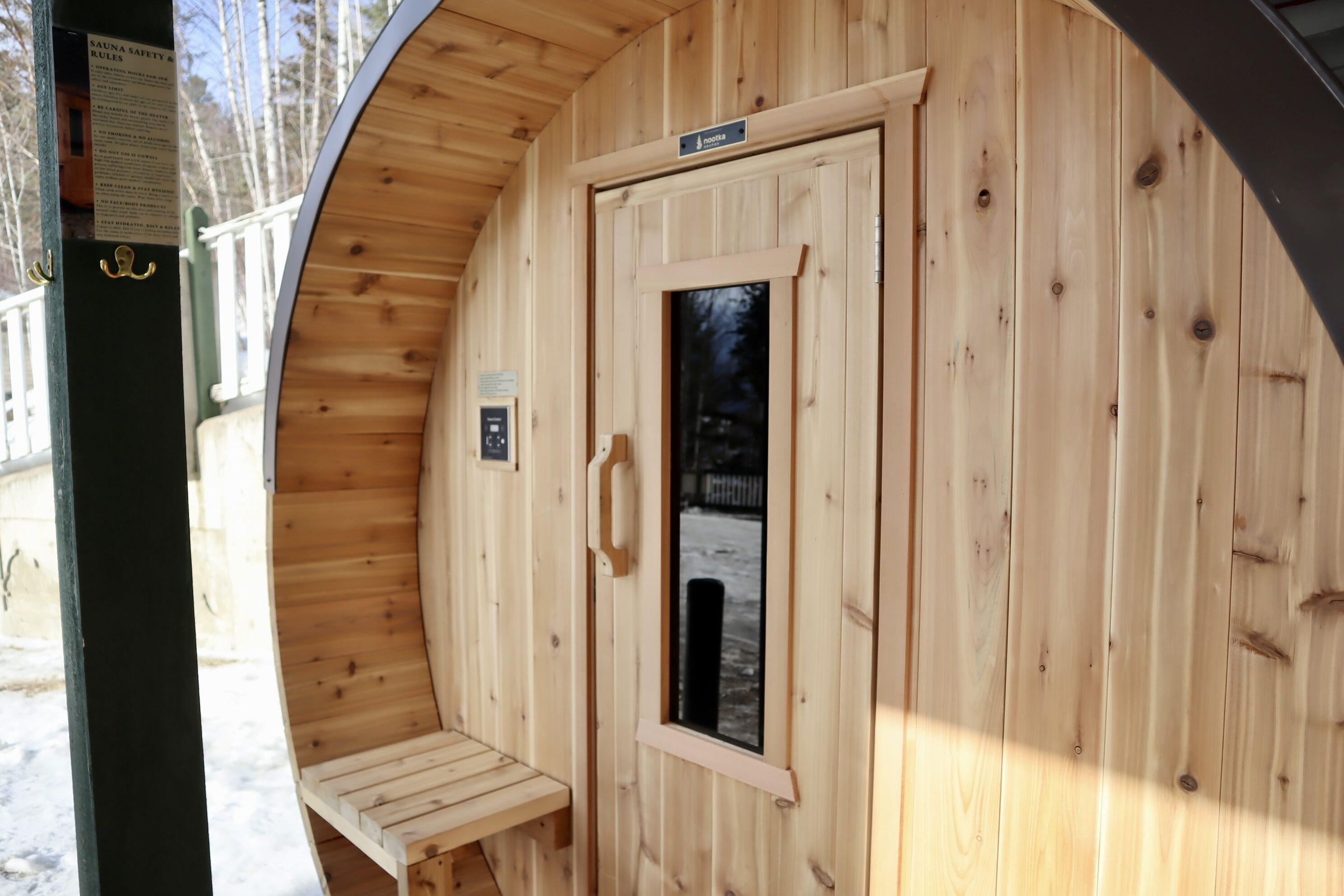 A sauna with wooden walls and a bench.