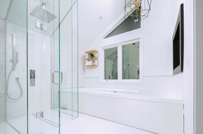 Bathtub, towels, soap, toilet paper