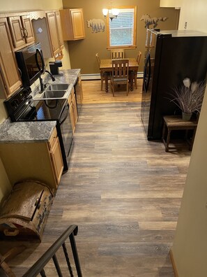 Enjoy family meals at the dining table, surrounded by ample kitchen space and natural storage.