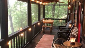 A covered porch with a wooden ceiling, string lights, a ceiling fan, and a view of the forest. - Big Sky Lodge - stunning view (Blue Ridge)