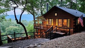 A wooden cabin with a balcony, a flag, and a view of the mountains. - Big Sky Lodge - stunning view (Blue Ridge)