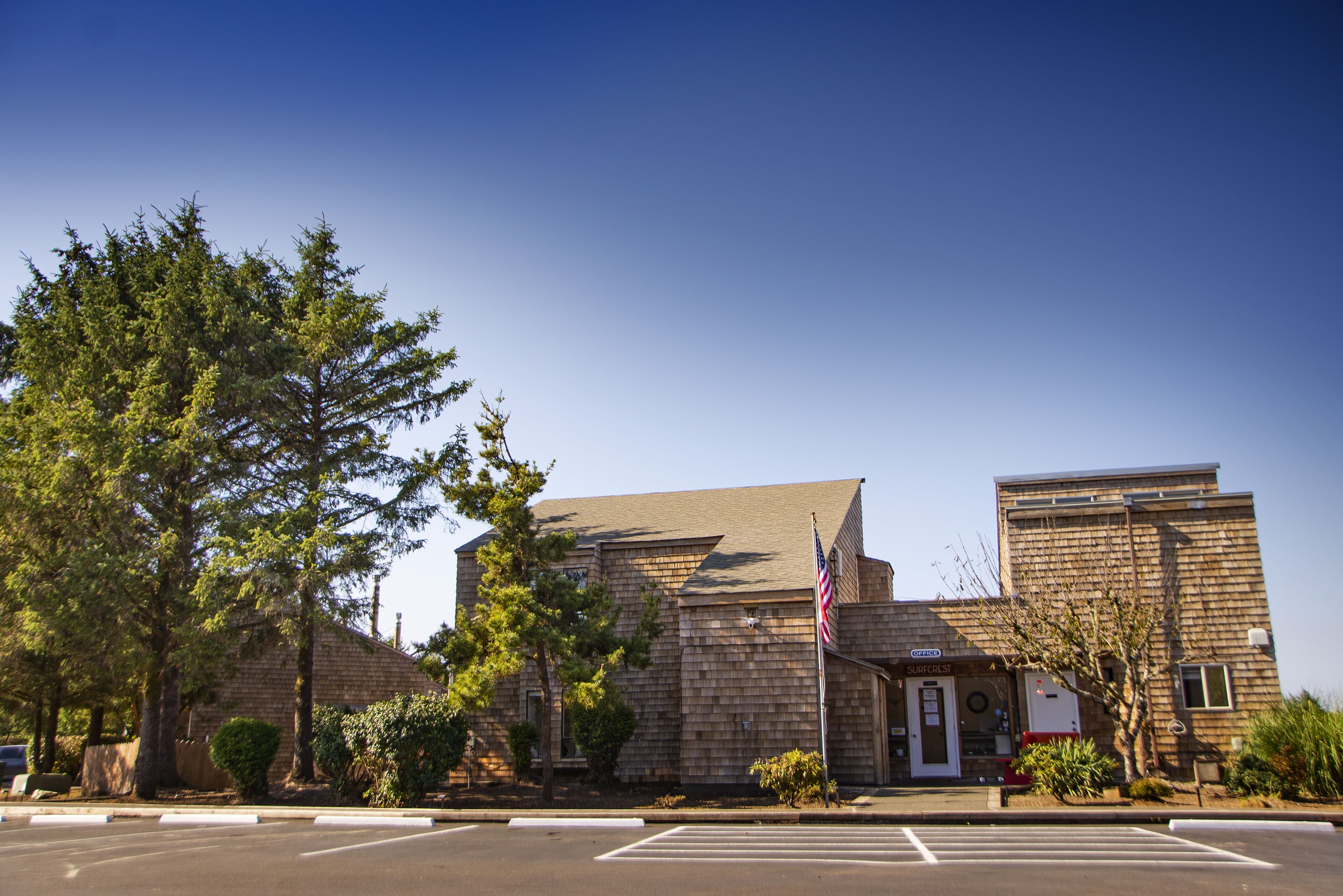 A two-story building with a brick facade and a small entrance.