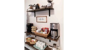 A kitchen area with shelves holding coffee-making equipment, a coffee grinder, and a scale. - The Farmhouse - Clean, comfortable, and affordable! (Fairbanks)
