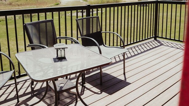 A deck with a table and chairs, overlooking a mountainous landscape. - T-00003) The Sante Fe (Sevier)