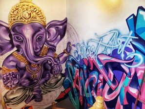 Vibrant artwork featuring a stylized elephant and the words 'Sweet Arts' adorns the wall.