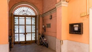 An arched doorway leading to a tiled corridor with a bicycle parked nearby. - Montemiletto a Panoramic Nest by Napoliapartments (Naples)