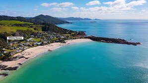 An aerial view of a coastal area with a beach, a cluster of houses, and a label pointing to 'White House'. - OUTSTANDING! WHITE HOUSE TASMANIA WINTER SPECIAL MIN STAY 2 NIGHTS TILL OCTOBER. (Boat Harbour Beach)