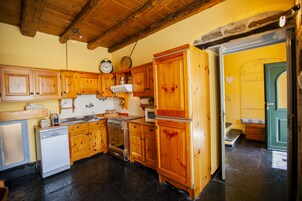 A kitchen with wooden cabinets, a dishwasher, a stove, and a microwave.