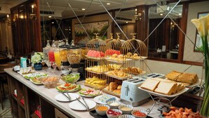 A buffet with various food items and a toaster. - The West Hotel & Spa (Hanoi)