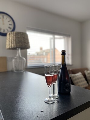 A table with two glasses of wine and a bottle of wine. - The Crows Nest - Sheringham (Sheringham)