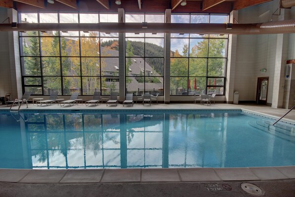 An indoor swimming pool with clear views of a mountainous landscape through large windows. - Pines 2129 (Keystone)