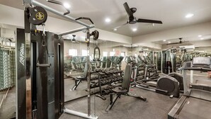 A gym with various exercise equipment, including a squat rack, dumbbells, and treadmills. - Burro's sweet suite W/ Heated Pool, GYM & Hot Tub (Scottsdale)